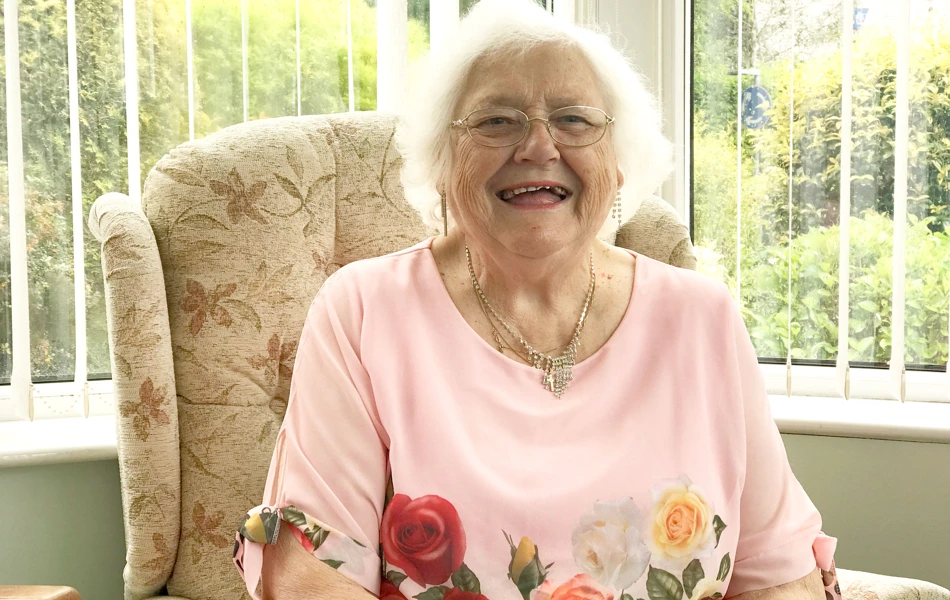 A smiling resident enjoying time at Treveor House