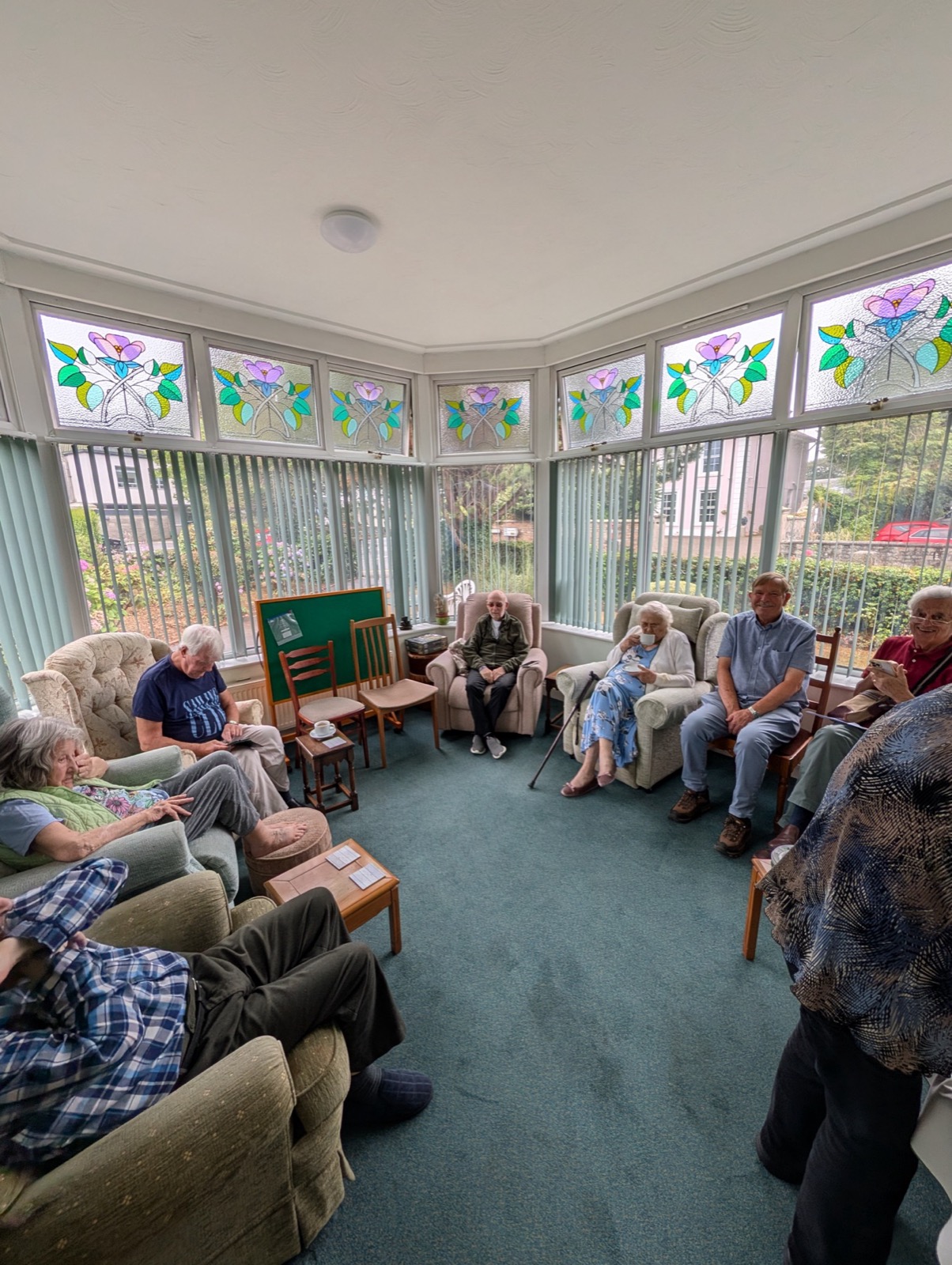 Residents and friends enjoying a coffee morning in the Treveor House conservatory